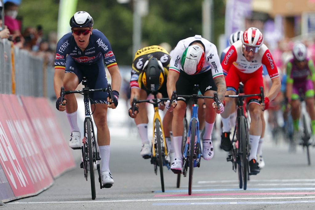 Team AlpecinFenix rider Belgiums Tim Merlier L crosses the finish line to win the second stage of the Giro dItalia 2021 cycling race 179 km between Stupinigi and Novara Piedmont on May 9 2021 Photo by Luca Bettini AFP Photo by LUCA BETTINIAFP via Getty Images