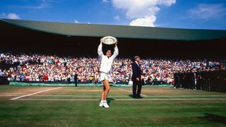 Martina Hingis of Switzerland with the Women's Single trophy after defeating Jana Novotna of the Czech Republic (not pictured) at The Wimbledon Lawn Tennis Championship at the All England Lawn and Tennis Club at Wimbledon on July 5th, 1997 in London, England.