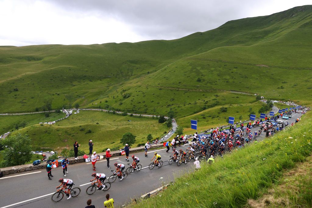 SAINTLARYSOULAN COL DU PORTET FRANCE JULY 14 Tadej Pogaar of Slovenia and UAETeam Emirates Yellow Leader Jersey and Teammates Jonas Vingegaard of Denmark and Team JumboVisma White Best Young Rider Jersey Wout Van Aert of Belgium and Team JumboVisma The Peloton passing through Col de Peyresourde 1569m during the 108th Tour de France 2021 Stage 17 a 1784km stage from Muret to SaintLarySoulan Col du Portet 2215m Landscape Mountains Fans Public LeTour TDF2021 on July 14 2021 in SaintLarySoulan Col du Portet France Photo by Tim de WaeleGetty Images