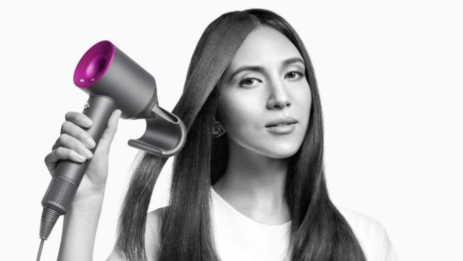 Woman using Dyson Supersonic hair dryer