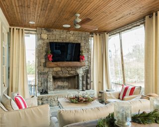 Wooden beadboard ceilings with white sofas in porch