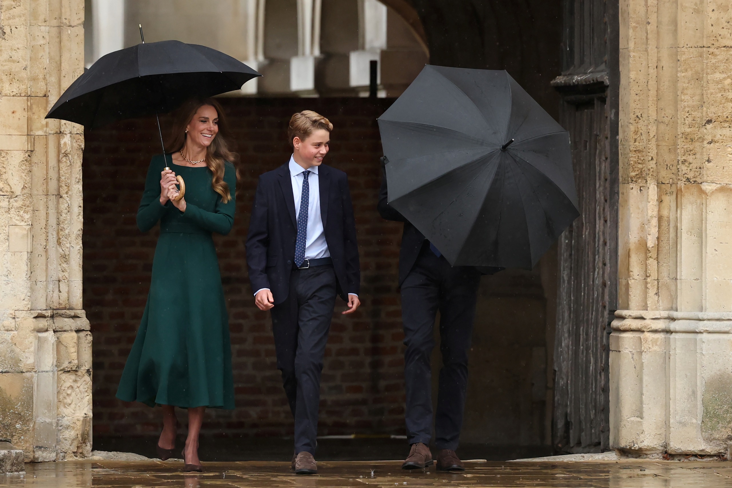 Princess Kate, Prince George walking next to Prince William blocked by an umbrella