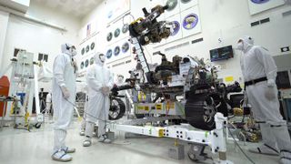 In this image, taken July 19, 2019, in the clean room of the Spacecraft Assembly Facility at NASA's Jet Propulsion Laboratory in California, the Mars 2020 rover's 7-foot-long (2.1 meters) arm maneuvers its 88-lb. (40 kilograms) sensor-laden turret as it moves from a deployed to a stowed configuration.