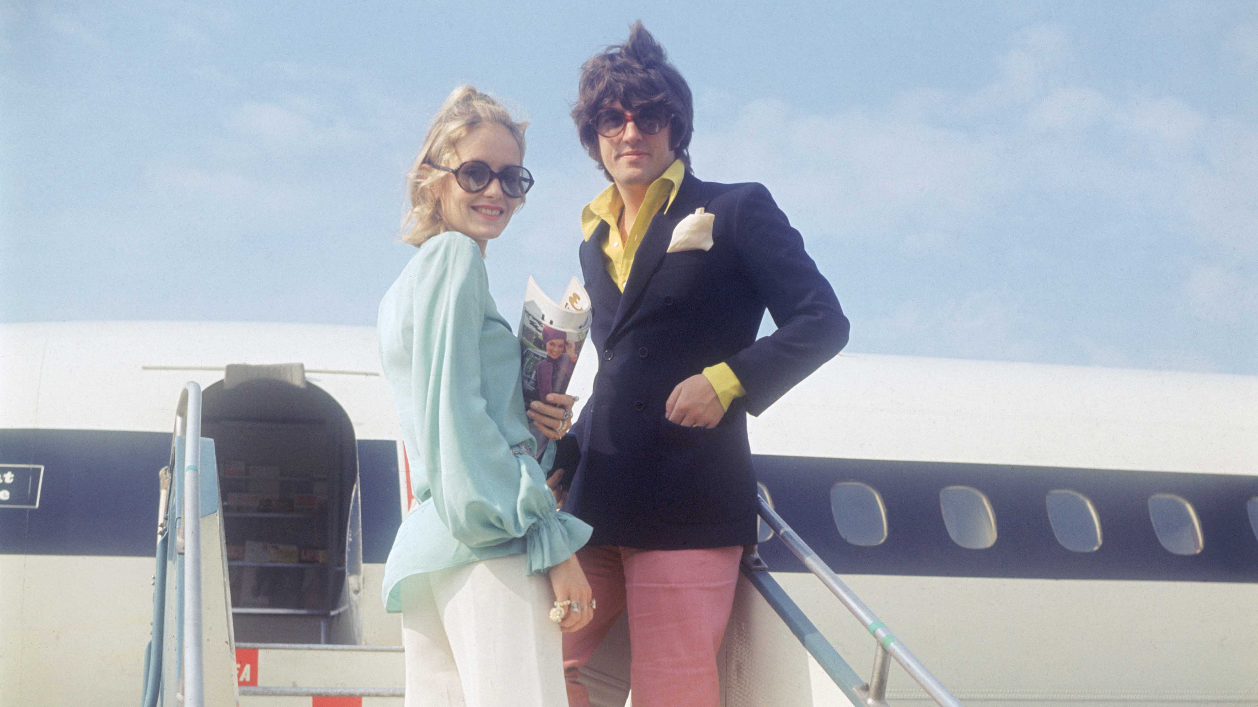 A woman and a man board an airplane 