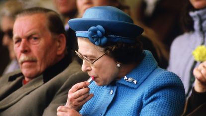 queen elizabeth ii putting on lipstick