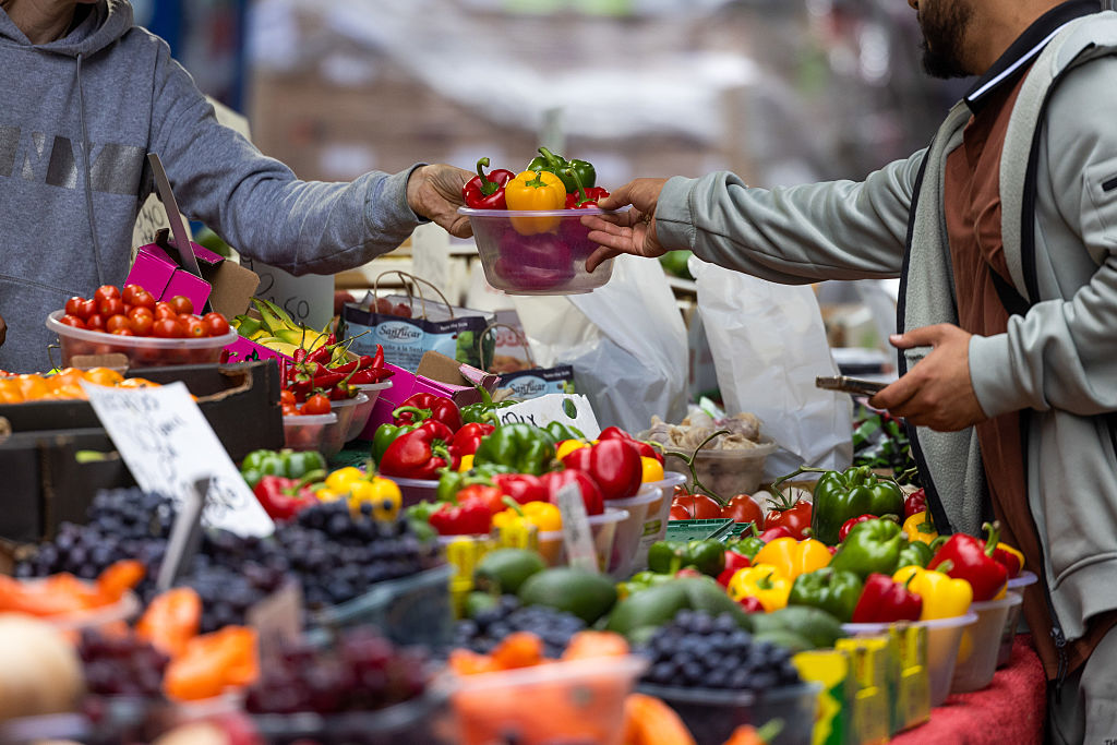 Customer buying peppers at a market