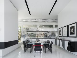 Double height, black and white dinning area in Castlegate Residence in the US