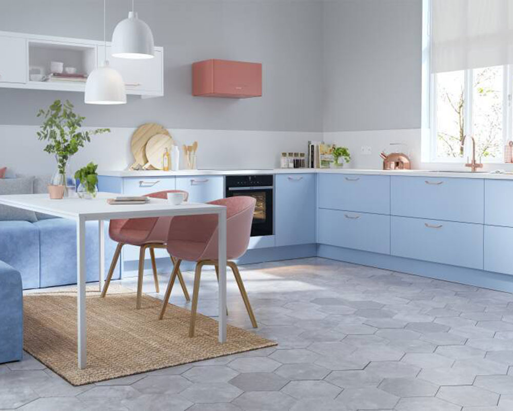 Baby blue kitchen with dining area and pink chairs by Wren