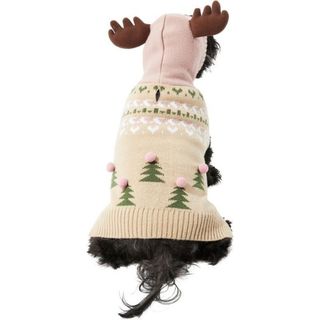 The back of a dog wearing a hooded tan fair isle sweater with antlers attached to the hood and Christmas tree designs on the back with small pink puff balls as stars, for Christmas sweaters for dogs.