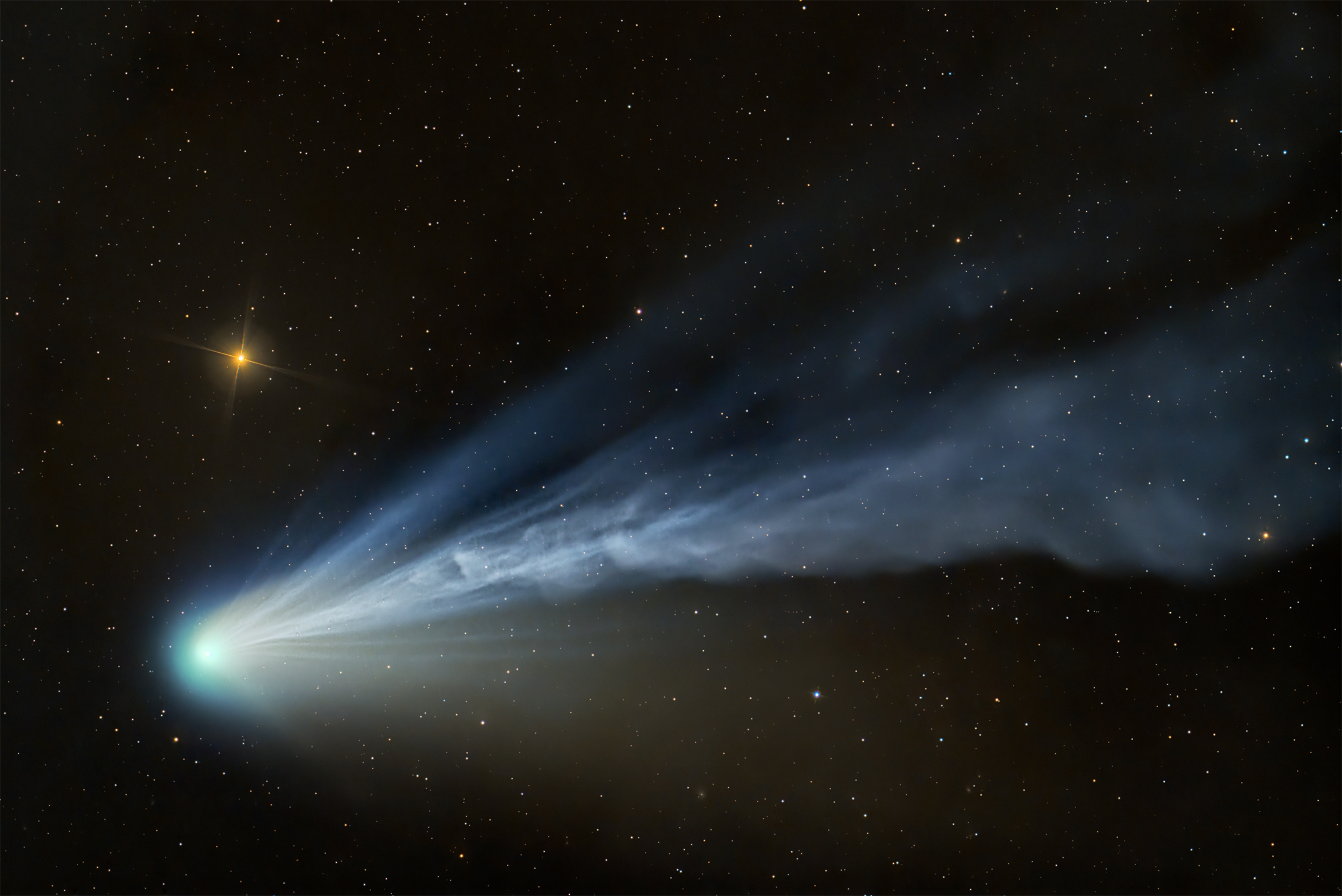a wisp of blue and white light on a starry background