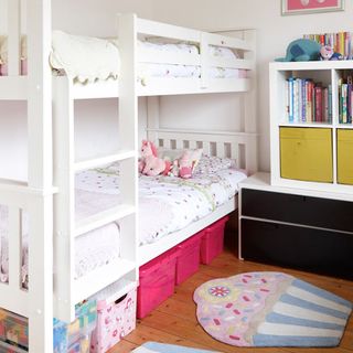 childrens room with bunk bed and storage boxes