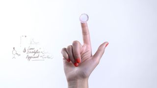 buly 1803 perfumed sticker for face masks held on a person's finger held against a white background