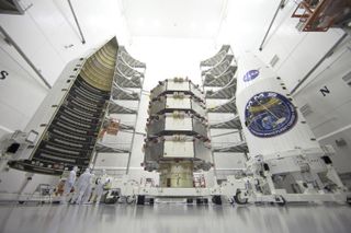 NASA's four Magnetospheric Multiscale mission satellites, stacked like a cake, are seen ahead of their planned launch from Cape Canaveral Air Force Station in Florida on March 12, 2015. Here, engineers in a clean room are processing the satellites for their liftoff.