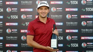 Todd Clements with a bottle of champagne after his ace at the Betfred British Masters