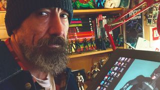 Lee Carter artist studio, a man sits in front of a Wacom tablet