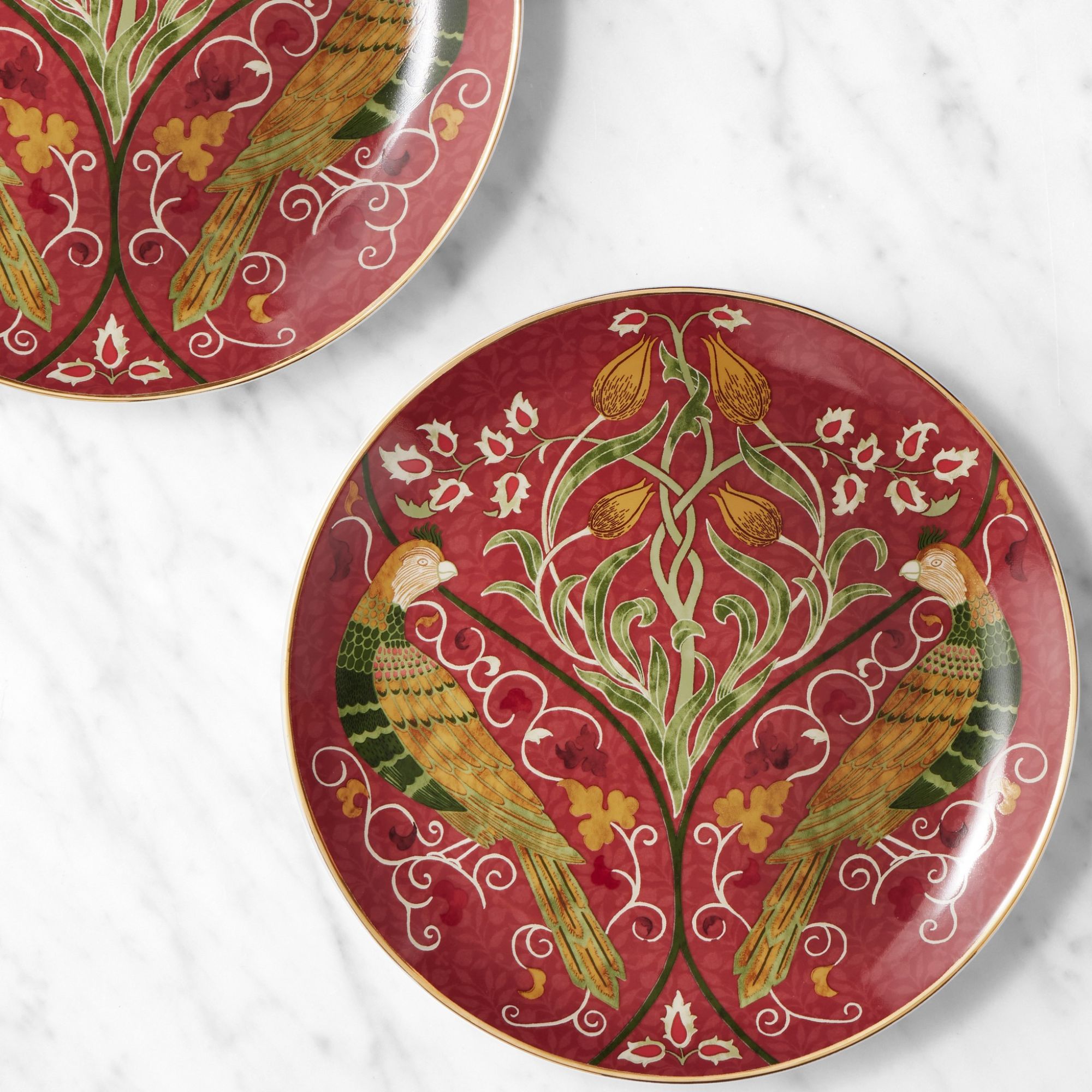 Red salad plates with botanical design and gold rims