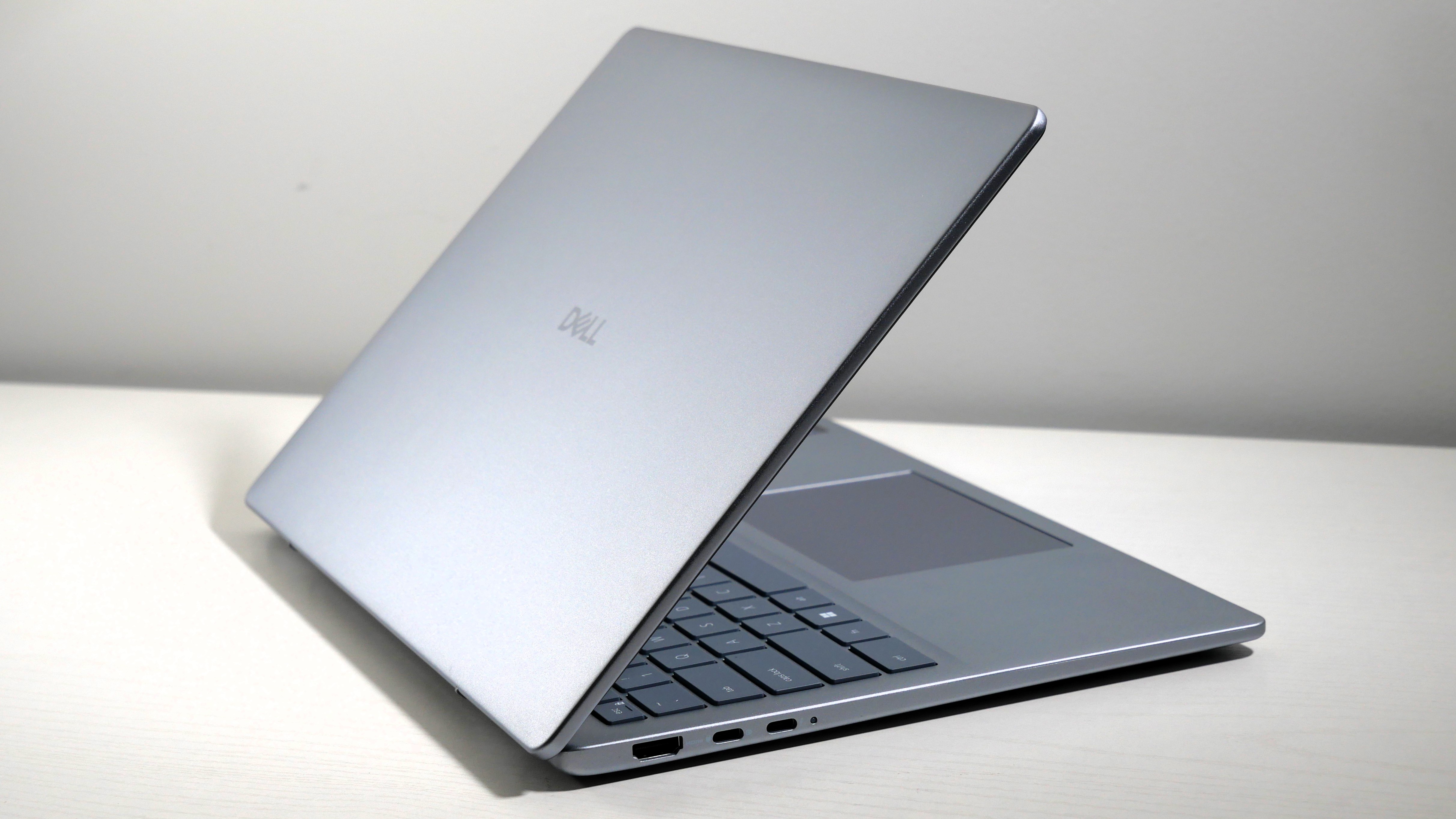Dell 14 Plus open at an angle, highlighting the lid and keyboard.