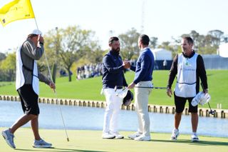 JJ Spaun and Rory McIlroy shake hands on the 18th green