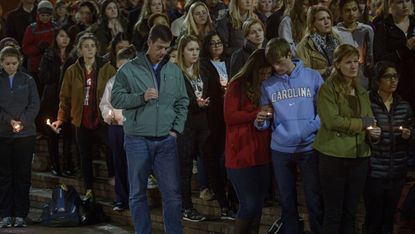 Peopleduring a vigil at the University of North Carolina following the murders of three Muslim students