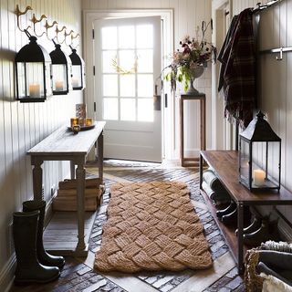 large sisal rug doormat on a stone floor in an entryway as a mudroom idea