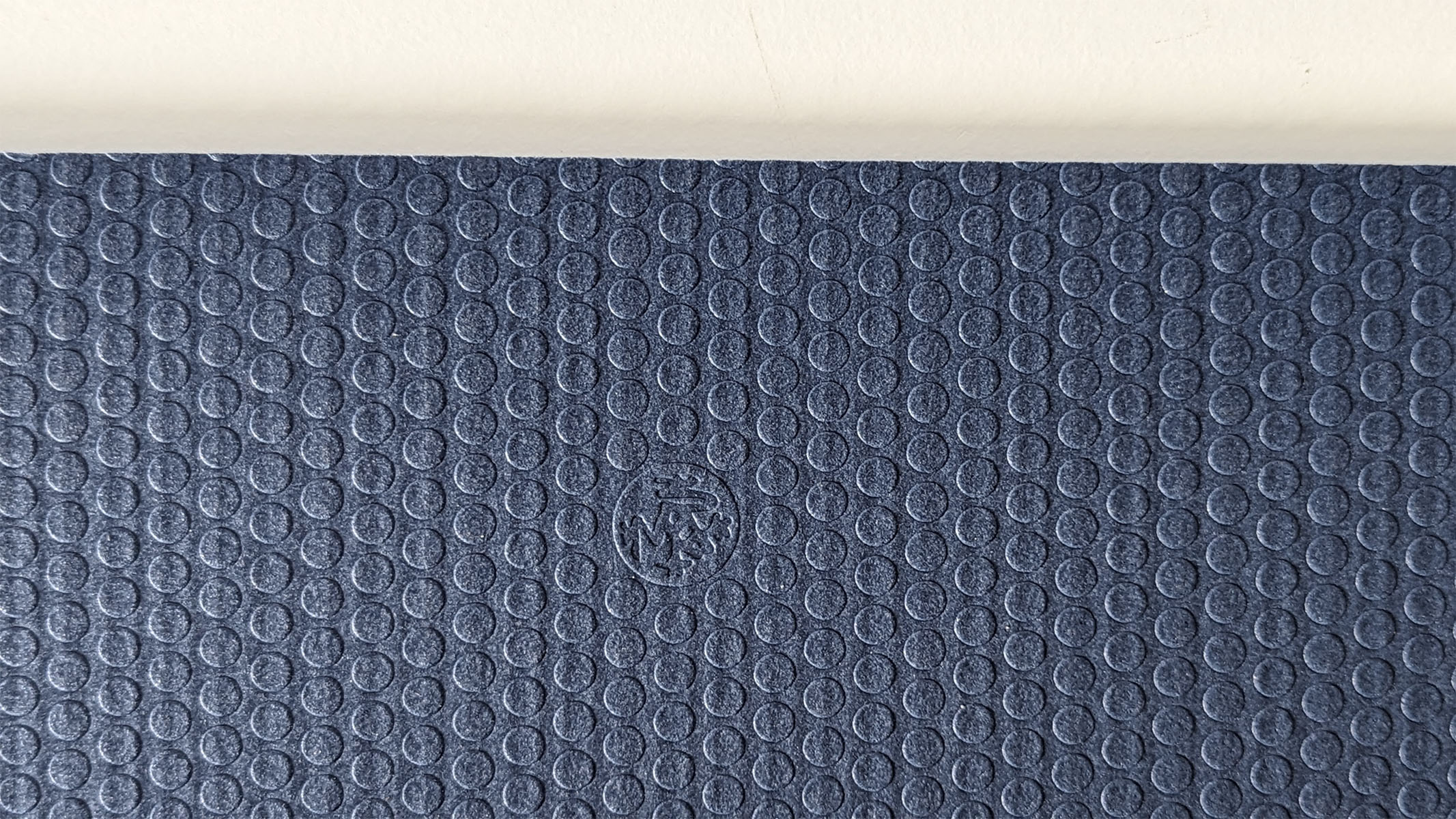 Close up of the circular textured side of the Manduka PRO yoga mat