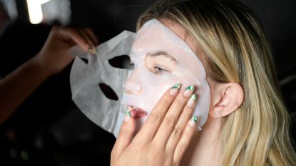 model with face mask backstage 