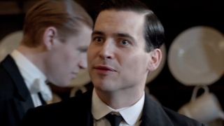 Robert James-Collier wears a mischievous smile in the downstairs kitchen in Downton Abbey.