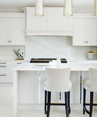 White room with white kitchen cabinet and backsplash