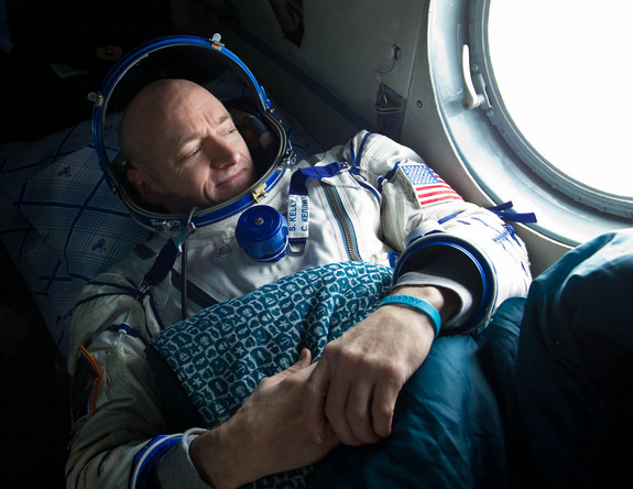 Expedition 26 commander Scott Kelly, wearing a turquoise wristband in honor of sister-in-law Gabrielle Giffords, looks out the window of a Russian Search and Rescue helicopter before the two hour helicopter ride to Kustanay, Kazakhstan shortly after he and fellow crew members Oleg Skripochka and Alexander Kaleri landed in their Soyuz TMA-01M capsule near the town of Arkalyk, Kazakhstan on Wednesday, March 16, 2011.