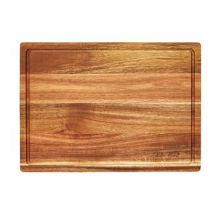 A rectangular wooden cutting board with a groove around the edge