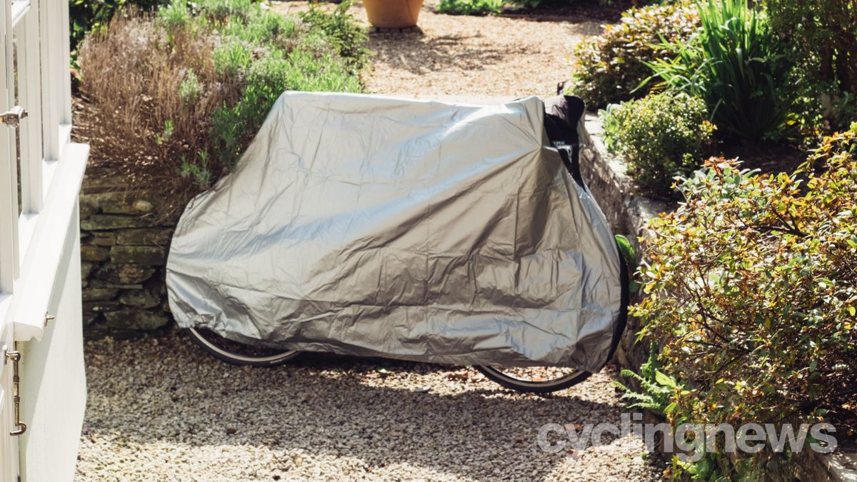 A silver bike cover over a road bike