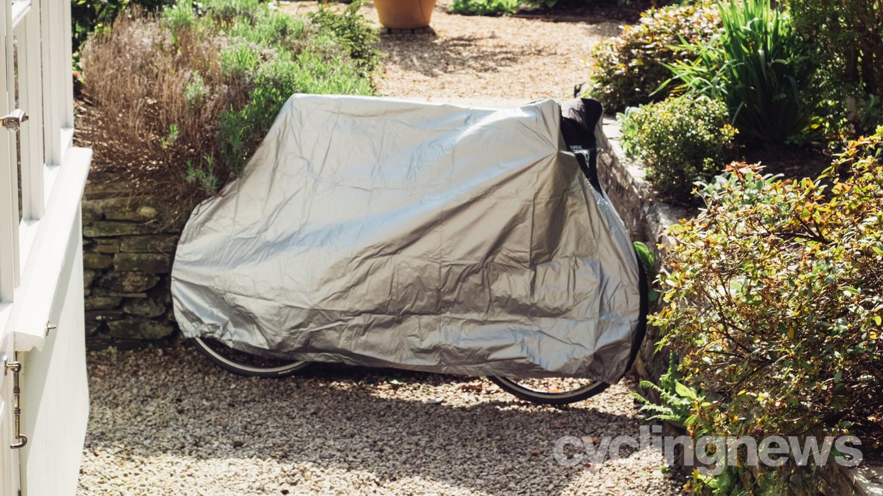 A silver bike cover over a road bike