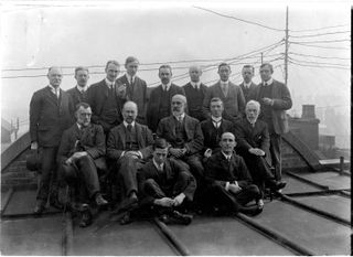 H. H. Thomas (back row, fifth from the left), stands with British Geological Survey members.