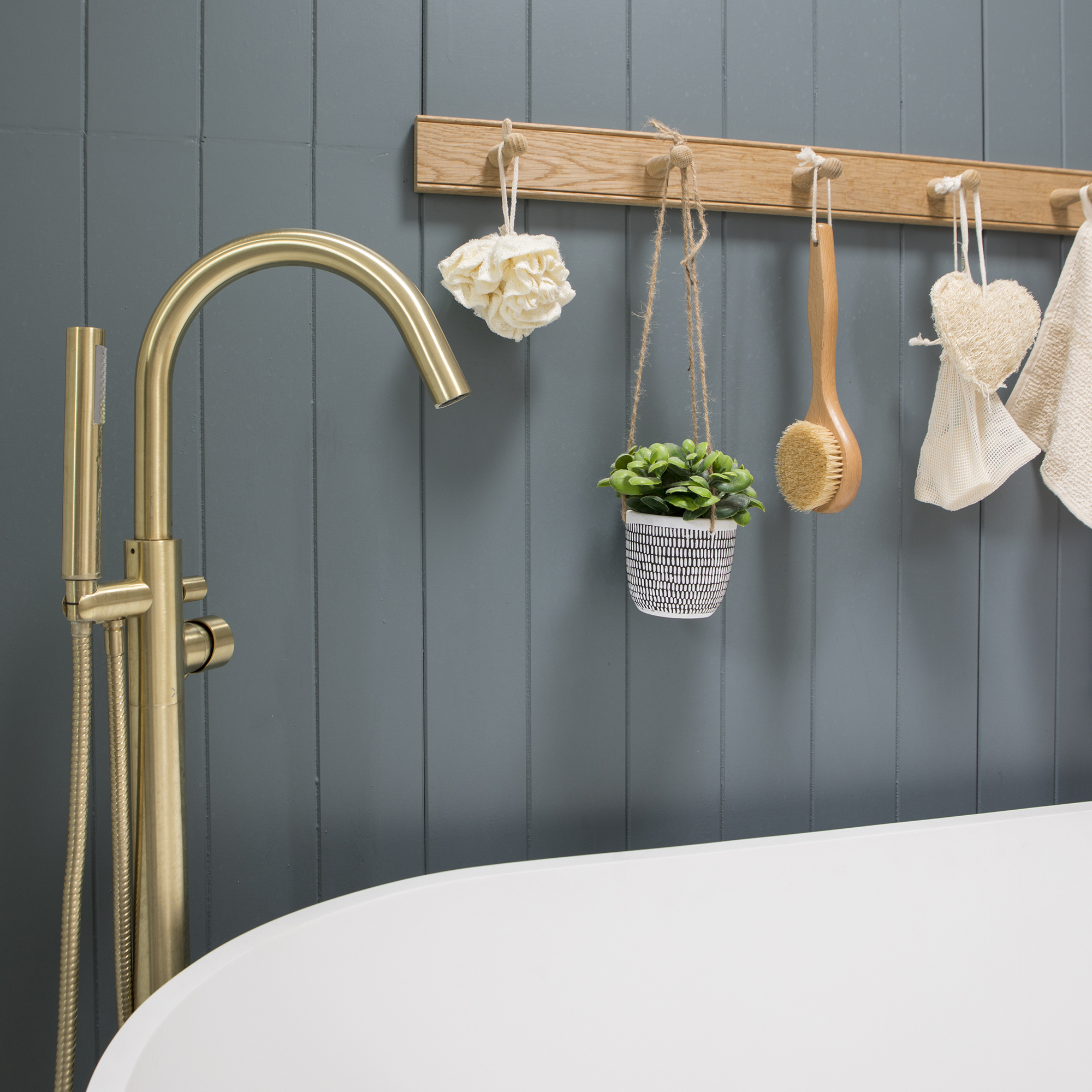 Coastal bathroom with blue panelled wall and wooden pegs