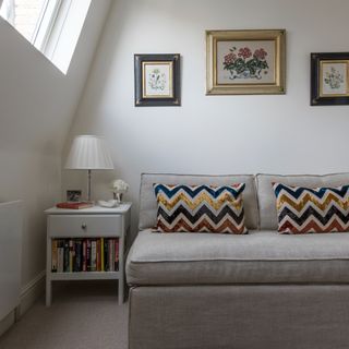 room with white wall and graphic cushions
