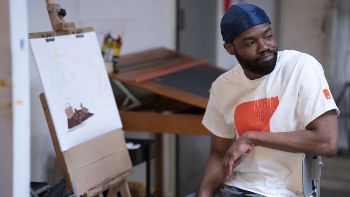 Kevin Iso as Kevin sitting in front of an art easel on Flatbush Misdemeanors