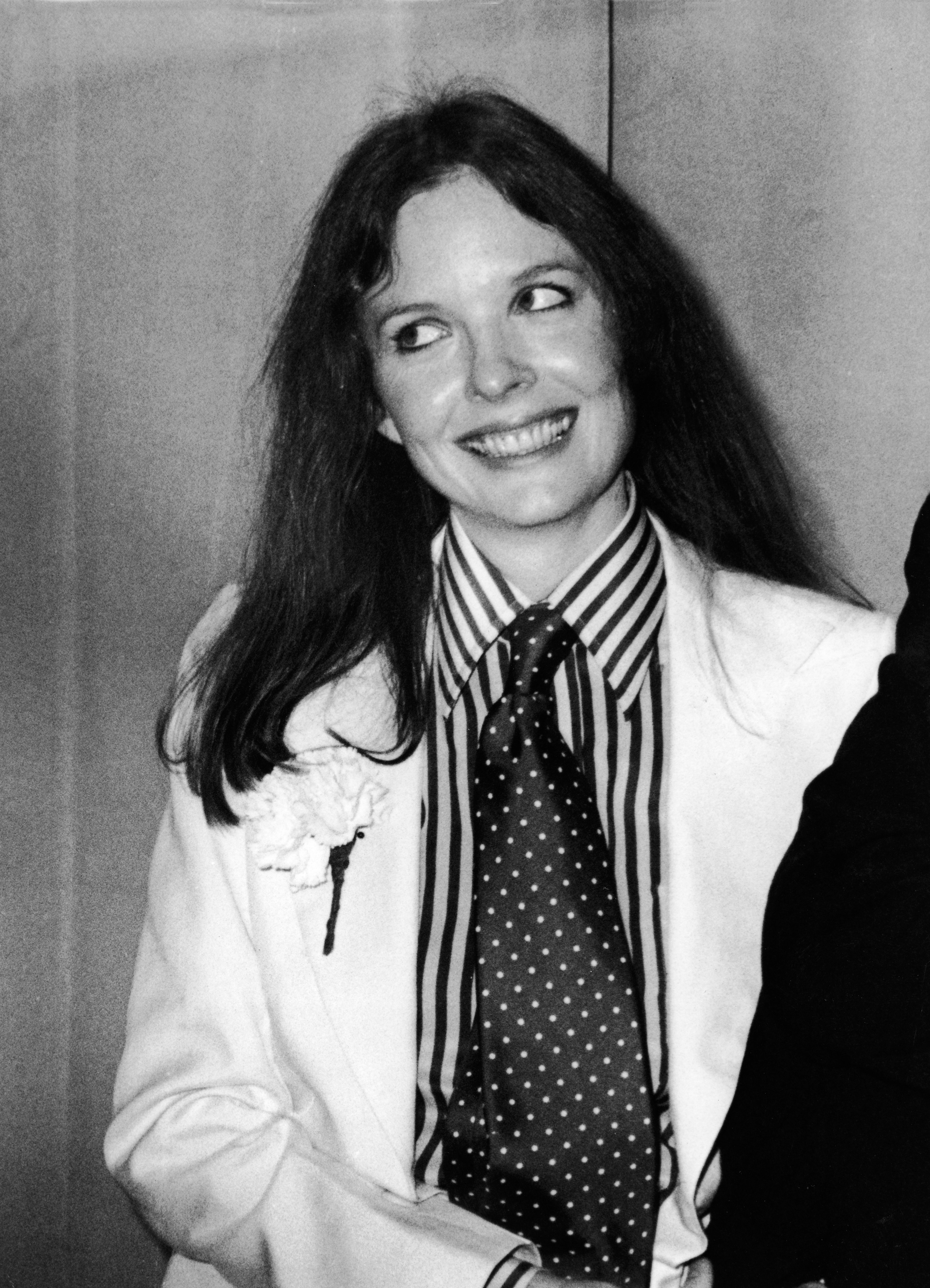 Diane Keaton's style evolution: Diane Keaton at the 48th Academy Awards and wears a white suit with a carnation in the lapel, striped shirt, and polka dot tie, Los Angeles, California, March 29, 1976. (Photo by Frank Edwards/Fotos International/Getty Images)