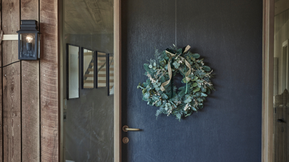 Wreath hanging on blue door.