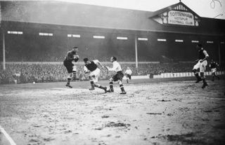 Arsenal goalkeeper Frank Moss saves from Tottenham's George Hunt at White Hart Lane in March 1935.