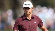 Collin Morikawa during The Players Championship wearing a maroon polo and white cap