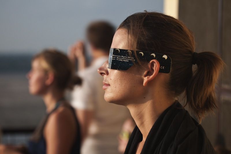 A woman watches a solar eclipse in India.