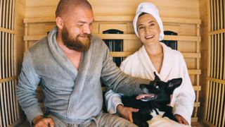 Couple in sauna with dog