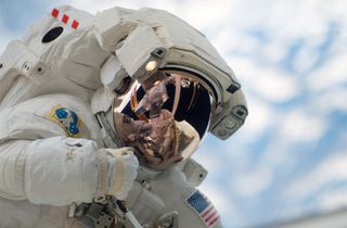 Astronaut Garrett Reisman spacewalks outside the International Space Station during the outpost's Expedition 16 mission.