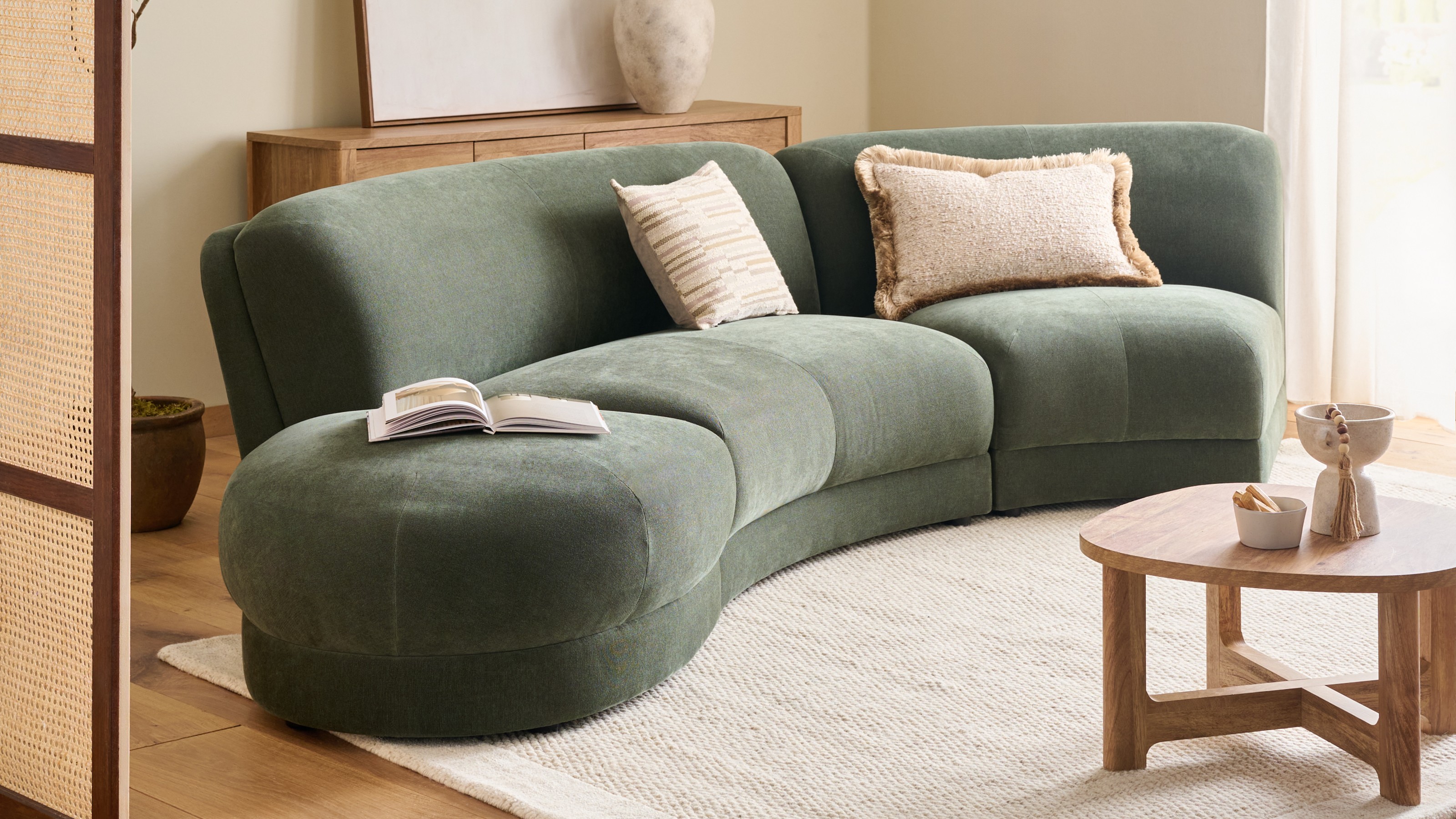 The Next Addison curved modular sofa in forest green soft twill in a neutral living room