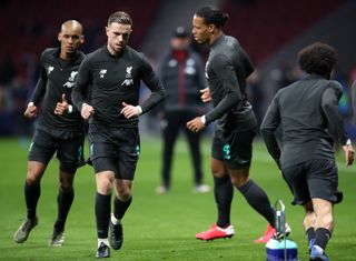 Fabinho, Jordan Henderson and Virgil van Dijk, left to second right, warm up with Liverpool