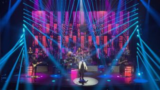 Lionel Ritchie takes the stage under a sea of blue and purple lights in Las Vegas.