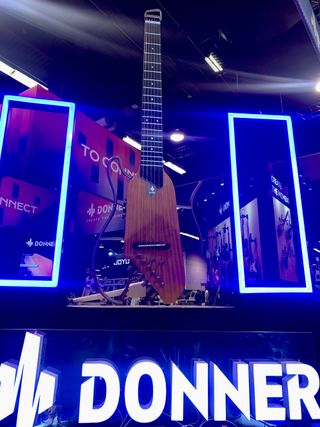An enormous Donner Hush-I guitar, displayed at the 2023 NAMM show