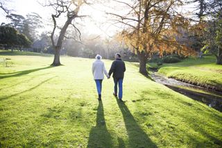 eldely couple walking together at the park