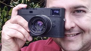 Sebastian Oakley holding Leica rangefinder camera