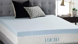 Linenspa vs Lucid mattress toppers: image shows the Lucid 4" Gel Memory Foam Mattress Topper on a gray fabric bed base